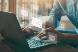 Person using a laptop for email marketing and customer relationship building.