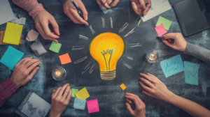 Creative team brainstorming with a lightbulb illustration on a chalkboard. Creative team brainstorming with a lightbulb illustration on a chalkboard.