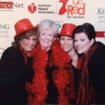 Windward Design Group - Meet Tina Marker Tina Marker with team members at a charity event, wearing red hats and feather boas.
